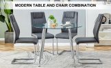 Table and chair set. (1 table+4 gray chairs) Round dining table with a 40 inch diameter glass tabletop and silver plated metal legs. 4 gray PU chairs